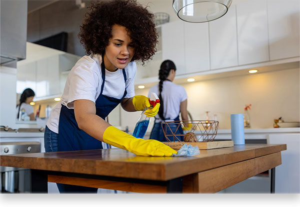 cleaning professionals sanitizing kitchen counters 